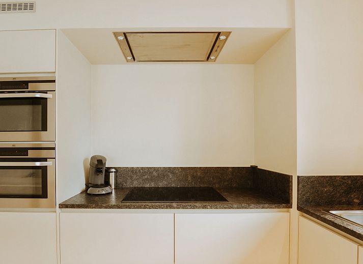 Modern kitchen in Apartment Goethe, close to the beach in De Haan, Belgian coast, with stylish decor and lots of natural light.