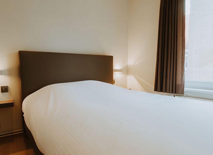 Attractive bedroom in Apartment Goethe, De Haan, Belgian coast, with comfortable bed and natural light for optimal relaxation.