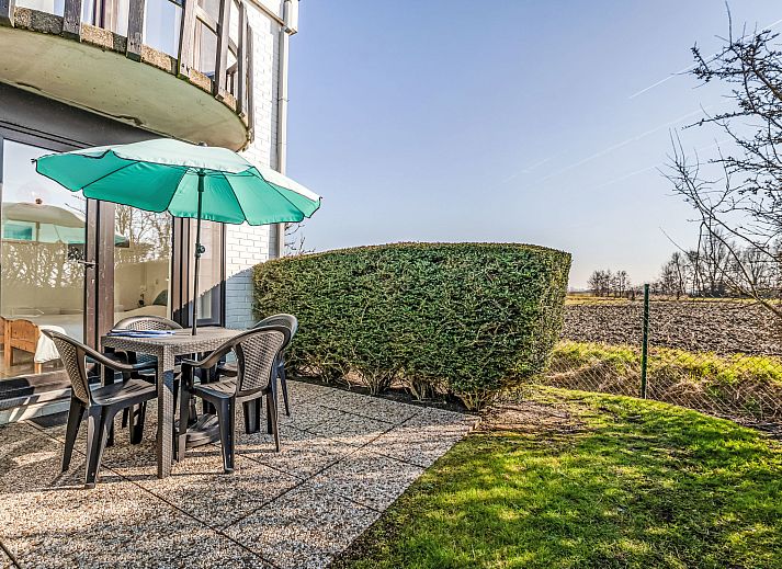 Enjoy the terrace at Apartment Sirius with parking and shared pool in De Haan, Belgian coast, overlooking nature.