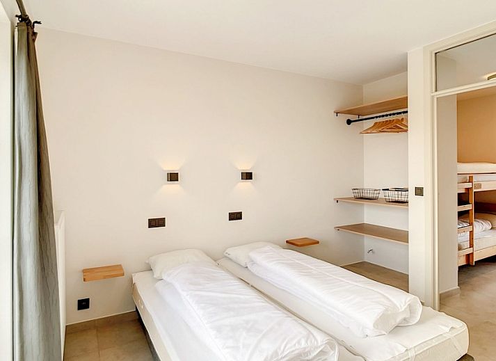 Gezellige entree met houten trap in Hoeve Langhof vakantiehuis, De Haan aan de Belgische kust.