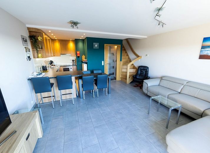 Bright living room in Huize Oesjoe, Bredene with comfortable sofa and large window for natural light.