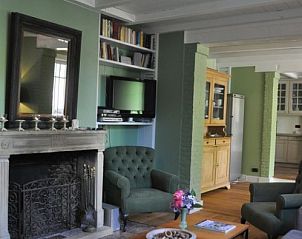 Cozy living room in Balsemboom Brugge vacation home, Bruges, West Flanders with fireplace and comfortable seating.