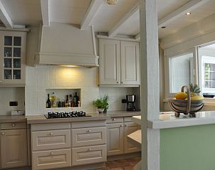 Attractive bedroom in Balsemboom Brugge vacation home, Bruges, West Flanders with rustic fireplace.