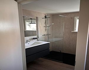 Modern bathroom in Villa Belle Haan, a vacation home in De Haan, West Flanders, with stylish shower and sink.