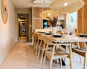 Gemtliches Esszimmer im Ferienhaus Suirir, De Haan, mit modernen Holzmbeln und stimmungsvoller Beleuchtung.