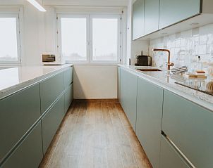 Modern kitchen in Apartment Residence Du Parc with sea view, located in De Haan, West Flanders, Belgium, with spacious countertops and views.