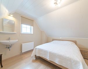 Attractive bedroom in Holiday Home Boonenhove No.57 in De Haan, West Flanders, Belgium, with comfortable bed and natural light.
