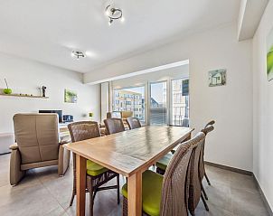 Cozy dining area in vacation home Azcona Two, Koksijde, with an inviting wooden table and plenty of natural light.