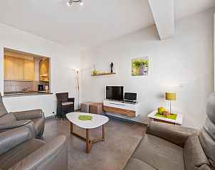 Cozy living room of vacation home Azcona Two in Koksijde, West Flanders, Belgium, with modern furnishings and comfortable seating.
