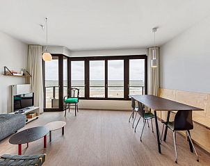 Spacious living room of vacation home De Meeuwen third in Koksijde, Belgium, with panoramic views of the West Flanders coastline.