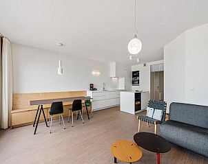Modern interior space of De Meeuwen third vacation home in Koksijde, West Flanders, with stylish kitchen and dining area.
