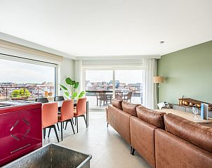 Spacious living room of La Bohme fifth vacation home in Koksijde, West Flanders, overlooking the terrace and the city.