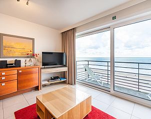 Les Petrels sixth vacation home in Koksijde, West Flanders with living room sea view and modern furnishings.