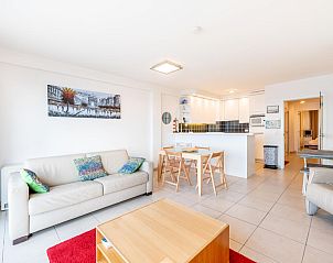 Cozy living room in Les Petrels sixth vacation home, Koksijde, Belgium, with modern kitchen and comfortable seating area.