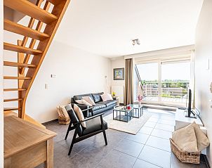 Lysa fourth vacation home in Koksijde, West Flanders with modern living room and view of terrace.