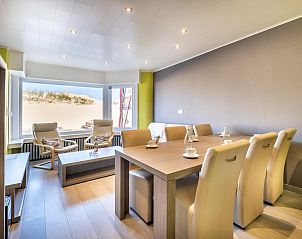 Stylishly furnished living room of vacation home Zeezicht GV in Koksijde, West Flanders overlooking the dunes.