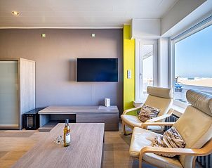 Cozy living room in vacation home Zeezicht GV in Koksijde, West Flanders, with modern interior and beautiful sea view.