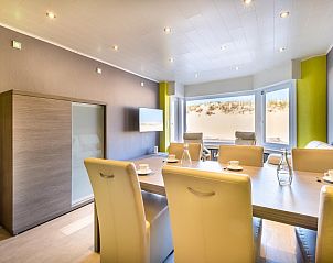 Modern dining room of vacation home Zeezicht GV in Koksijde, Belgium, overlooking the dunes and stylish decor.