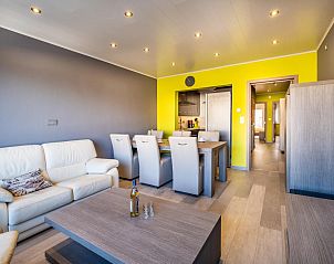 Cozy living room of Zeezicht GV vacation home in Koksijde, West Flanders, Belgium with modern furnishings and comfortable seating area.