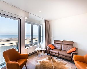 Stylish living room of LaVue Deux vacation home in Koksijde, West Flanders with beautiful sea view and comfortable seating area.
