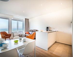 Modern living room of LaVue Deux vacation home in Koksijde, Belgium, with sea view and stylish decor for a relaxing stay.