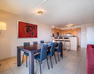 Spacious dining room and kitchen in vacation home Paco Vierde, Koksijde, West Flanders. Cozy indoor space with modern decor and artwork.