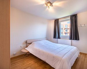 Cozy bedroom in vacation home Paco Vierde, Koksijde, West Flanders, with comfortable bed and natural light through the window.