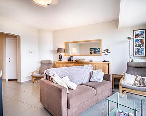 Cozy living room of vacation home Vitelli fourth in Koksijde, West Flanders, with comfortable seating area and modern furnishings.