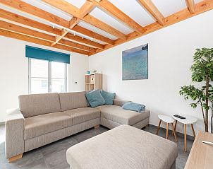 Cozy living room in vacation home Westhinder I H89 in Koksijde, West Flanders, with comfortable sitting area and modern furnishings.