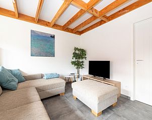 Cozy living room in vacation home Westhinder I H89 in Koksijde, West Flanders, with comfortable sitting area and modern furnishings.