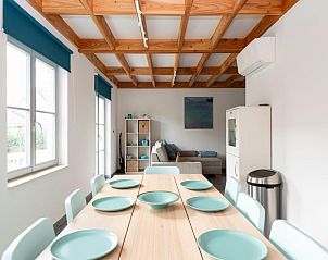 Interior of vacation home Westhinder I H89 in Koksijde, West Flanders with modern dining room and comfortable sitting area.