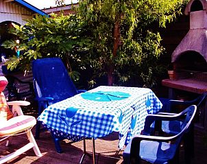 Sunny terrace of vacation home Katica in Bredene, West Flanders with garden furniture and barbecue