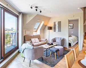 Gezellige woonkamer van vakantiehuis Donny in De Panne, West-Vlaanderen met comfortabele zithoek en uitzicht op de omgeving.