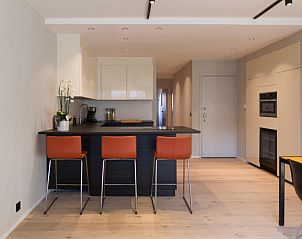 Modern kitchen with bar in Residence Commodore No. 135, apartment in Knokke, West Flanders, Belgium for comfortable cooking.