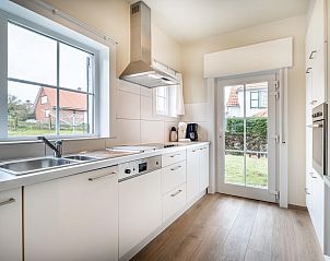 Moderne keuken in vakantiehuis LaCte in Sint-Idesbald, West-Vlaanderen, met uitzicht op de tuin en veel natuurlijk licht.