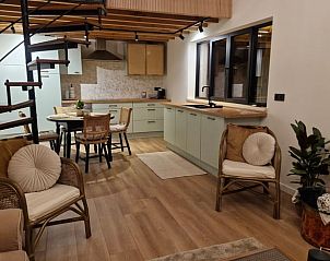 Cozy interior of cottage in Ruiselede, West Flanders: modern kitchen and cozy sitting area in vacation home.