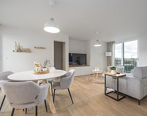Stylish living room in vacation home Castor - 0102, Middelkerke, Belgium with modern interior and view from the balcony.