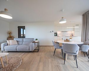 Stylish living room of vacation home Castor - 0102 in Middelkerke, West Flanders, with modern furnishings and spacious seating area.