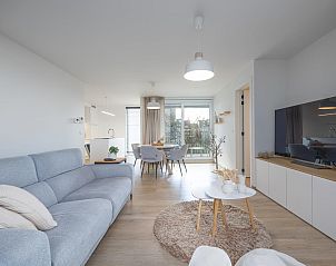 Modern living room in holiday home Castor - 0102, Middelkerke, with light interior and view of the terrace, West Flanders, Belgium.