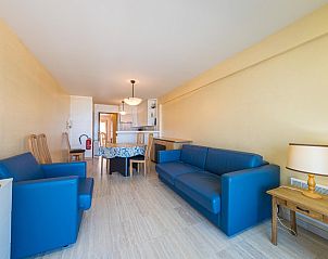 Bright living room in Azur Palace - 0602, vacation home in Middelkerke, West Flanders, with comfortable blue sofas and a cozy dining area.