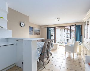 Spacious living room in vacation home Green Garden block 1 - 0105 in Middelkerke, West Flanders, overlooking balcony and modern furnishings.