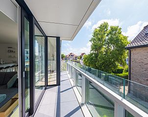 Enjoy the sun-drenched balcony of vacation home Matisse in Middelkerke, West Flanders, with beautiful views of the green surroundings.
