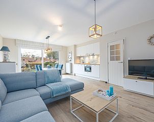 Stylish living room of Lotus - 0003 vacation home in Westende, West Flanders, with modern kitchen and views of the peaceful surroundings.