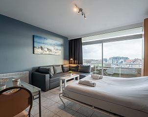 Cozy interior space of Apartment Studio 502 in Bredene, West Flanders with city views and comfortably furnished sleeping and sitting area.