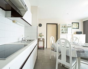 Bright kitchen and dining area in Apartment Ref. 704 in Bredene, West Flanders, ideal vacation home for comfort and coziness.