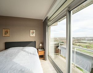 Bedroom in Apartment Ref. 704 in Bredene, West Flanders with comfortable bed and panoramic view of the green surroundings.