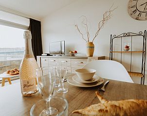Cozy dining area in Apartment Seastar, Bredene, overlooking terrace. Ideal vacation accommodation in West Flanders, Belgium.