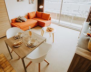 Cozy interior space of Apartment Seastar in Bredene, West Flanders, with modern living room and terrace view.