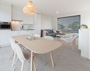Modern living room and kitchen in Holiday Home De Garnaal, Bredene, West Flanders, Belgium, with stylish furnishings and spacious dining area.