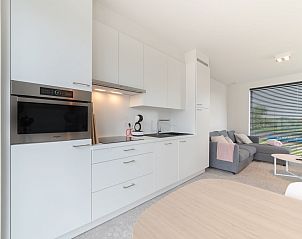 Modern kitchen and living room in Holiday Home De Garnaal, Bredene, West Flanders, ideal for a comfortable stay at the Belgian coast.